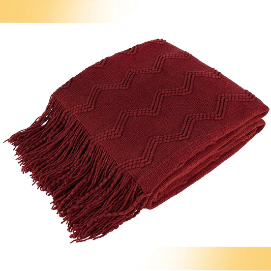 Burgundy throw blanket draped over a beige sofa, adding warmth and style to any living space.