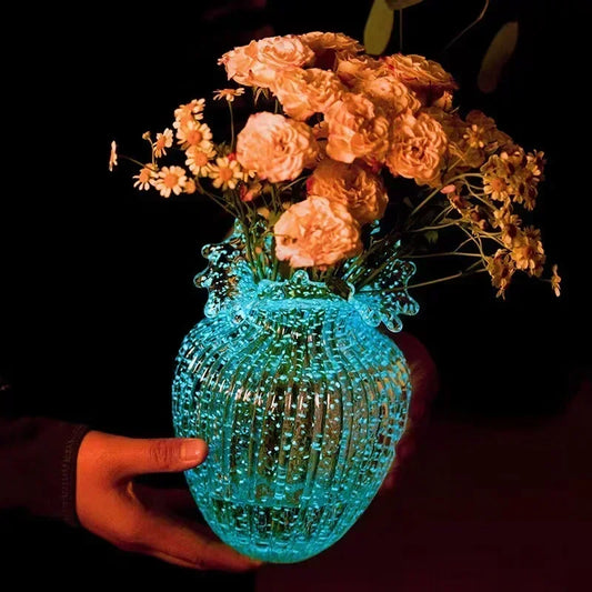 Elegant Luminous Ornamental Glass Flower Vase displayed with fresh flowers, a stunning decorative glass vase.