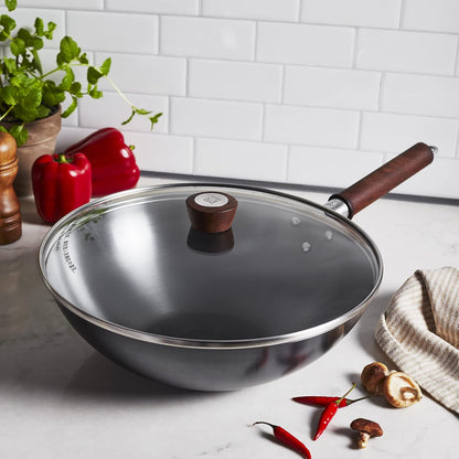12-Inch Carbon Steel Wok showcasing a riveted walnut handle and tempered glass lid for easy cooking.