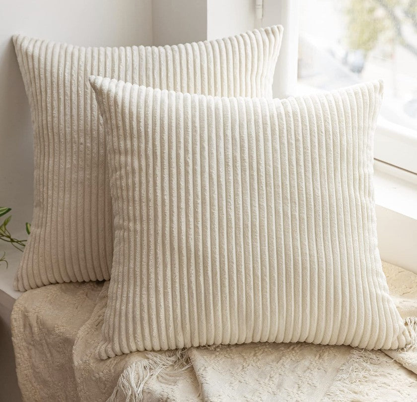Set of 2 cream throw pillow covers on a neutral sofa, demonstrating how they enhance the comfort and style of any living space.