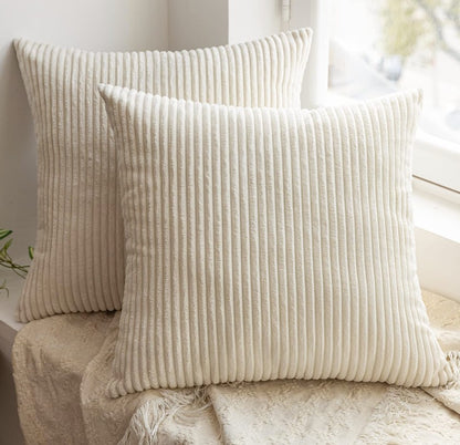 Set of 2 cream throw pillow covers on a neutral sofa, demonstrating how they enhance the comfort and style of any living space.