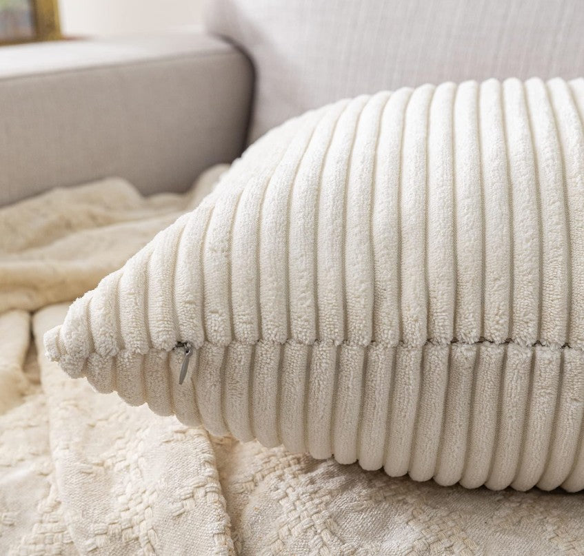 Cream Corduroy Throw Pillow Covers 18x18 arranged on a bed, showcasing their decorative appeal and plush comfort for restful spaces.