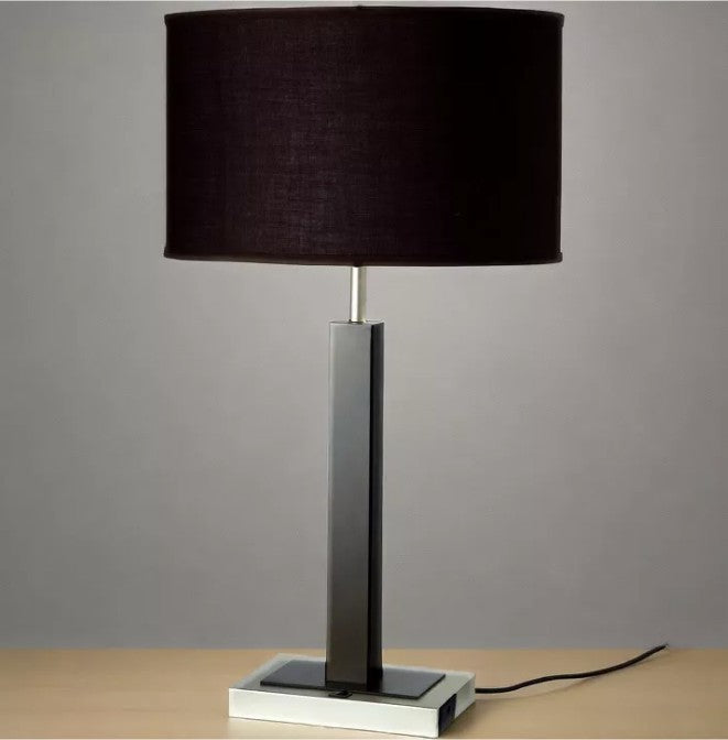 30” Modern Black Table Lamp on a nightstand, designed as a stunning modern black lamp that gives soft ambient light.