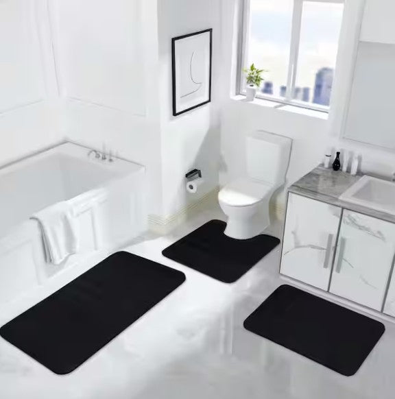 Stylish arrangement of the Black Memory Foam Bathroom Rug Set with complementary white towels and decor.