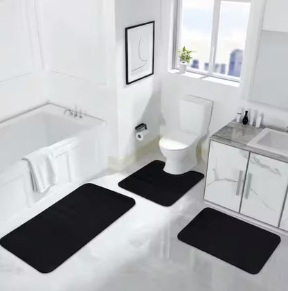 Stylish arrangement of the Black Memory Foam Bathroom Rug Set with complementary white towels and decor.