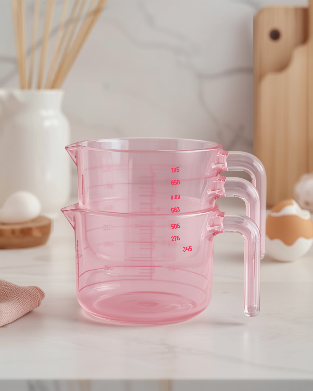 Pink glass measuring cups trio in a modern kitchen setup, perfect for capturing beautiful recipes.