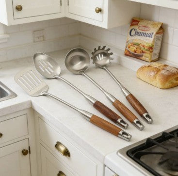 4-Piece 304 Stainless Steel Kitchen Utensil Set with Natural Wood Handles arranged for cooking, serving, and draining