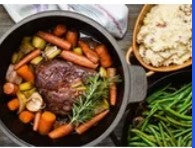5.2 QT Pre-Seasoned Cast Iron Dutch Oven with a warm meal, symbolizing comfort food tradition.
