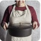 STAUB 6.25-Quart Wide Oval Dutch Oven, Dark Blue Enameled Cast Iron with Self-Basting Lid, side angle highlighting the oval shape and durable enamel finish