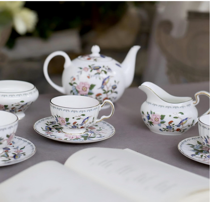 Vibrant and artistic rendition of the Aynsley Tea Set with colorful teacups and floral motifs.