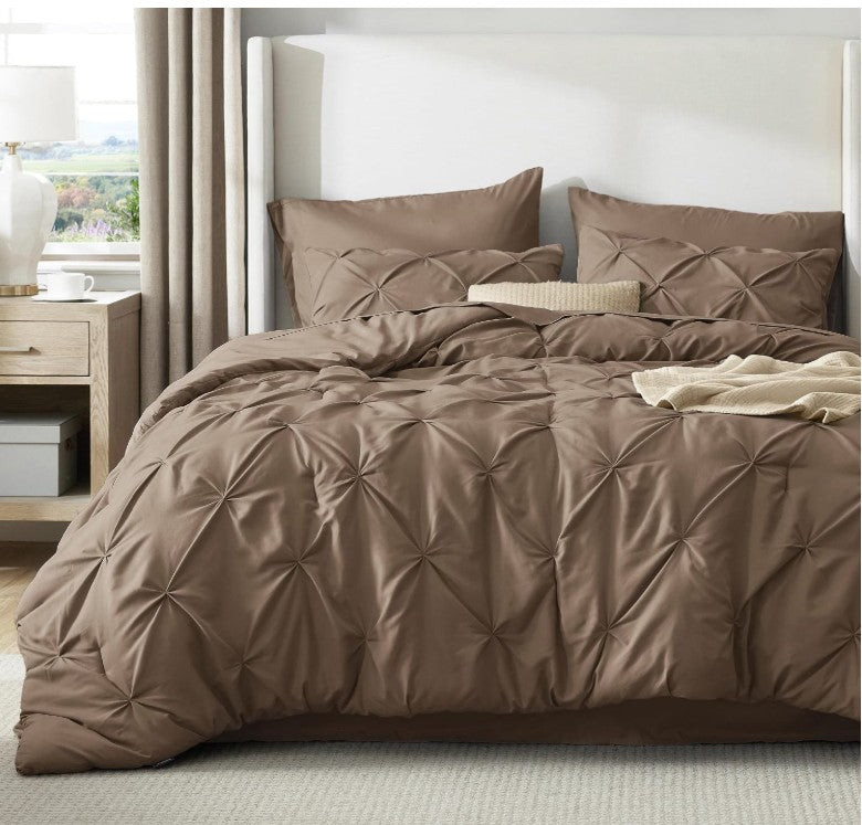 The Queen 7-Piece Pintuck Comforter Set combines functionality and style, perfect for modernizing your bedroom with ease.