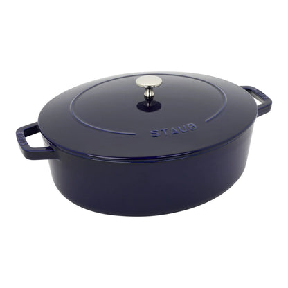 STAUB 6.25-Quart Wide Oval Dutch Oven, Dark Blue Enameled Cast Iron with Self-Basting Lid, open view showing the enameled interior of a wide oval dutch oven