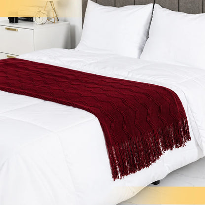 Burgundy throw blanket folded neatly on the edge of a bed, perfect for a stylish bedroom upgrade.