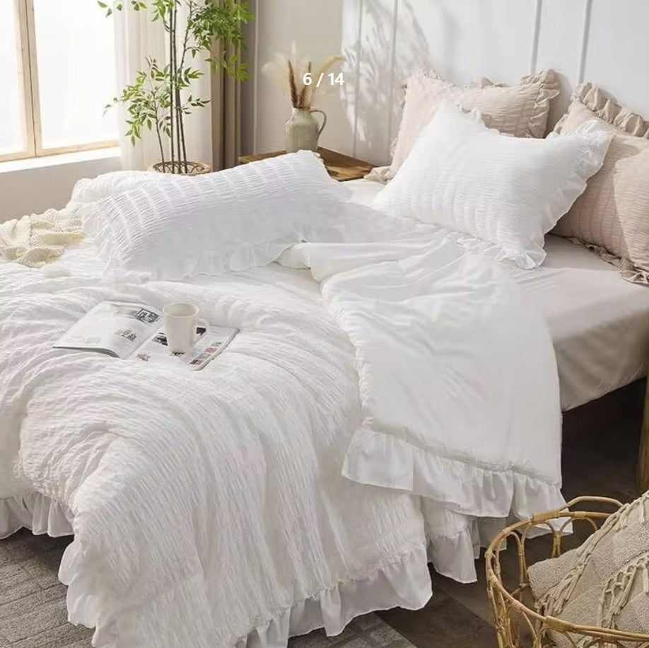 Cozy setup in a bedroom with the White Ruffle Comforter Set accentuated by neutral tones and textures.