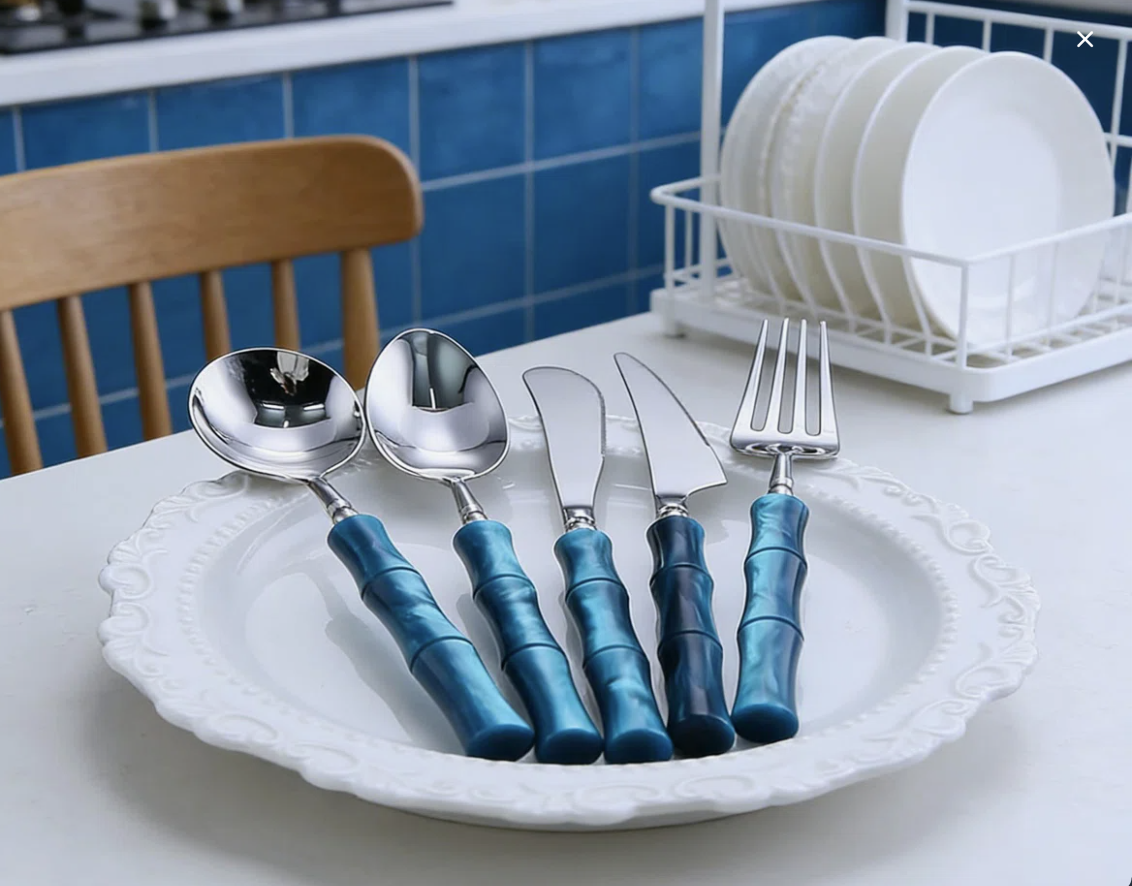 Artful arrangement of Flatware Set with bamboo-style green acrylic handles and stainless steel cutlery displayed on a modern table for special occasions.