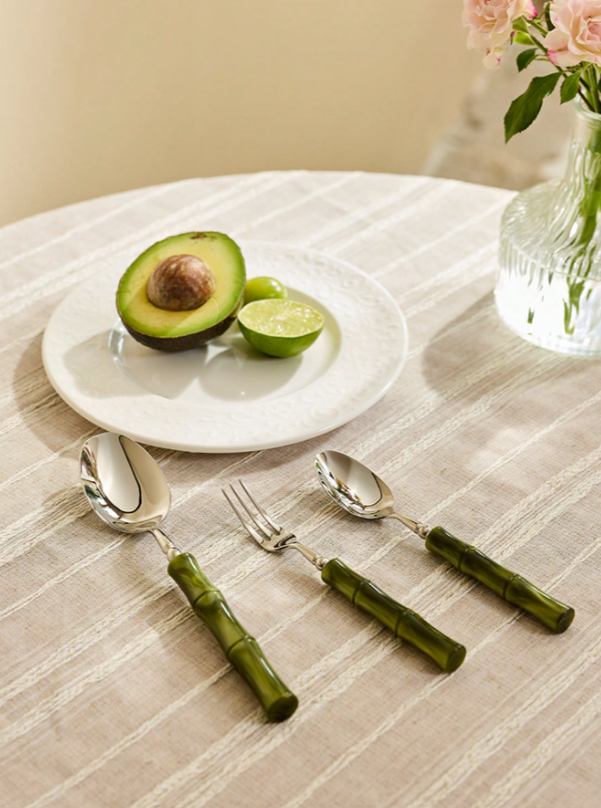 Stylish display of the Flatware Set 18/10 stainless steel cutlery, focusing on the unique bamboo-style green handles for an upscale dining aesthetic.