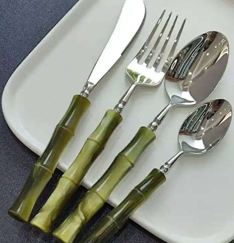 Close-up detail of the 18/10 stainless steel cutlery in the Flatware Set showing the craftsmanship with bamboo-style handles, ideal for stylish entertaining.