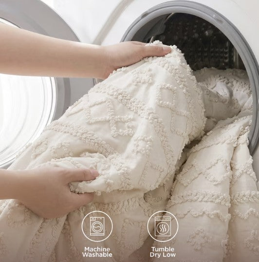 The Luxury Tufted Beige Comforter Set showcased with decorative elements, perfect for a cozy, stylish bedroom.