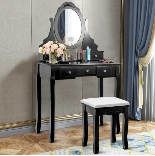 Modern makeup vanity setup featuring a stylish lamp and scented candle for a cozy ambiance.