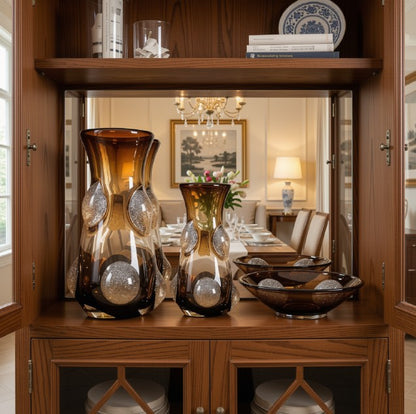 The Coffee Art Glass Nordic Vase styled with green foliage, displaying its function as a modern glass vase in decor.