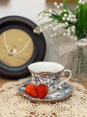 Artistic display of the Vintage Blue Floral Bone China Tea Set paired with delicate pastries.