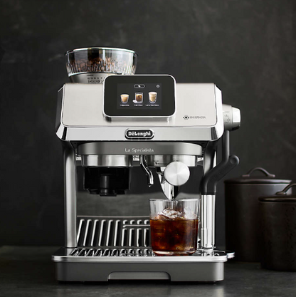De'Longhi La Specialista Touch Espresso Machine with rich coffee steaming.