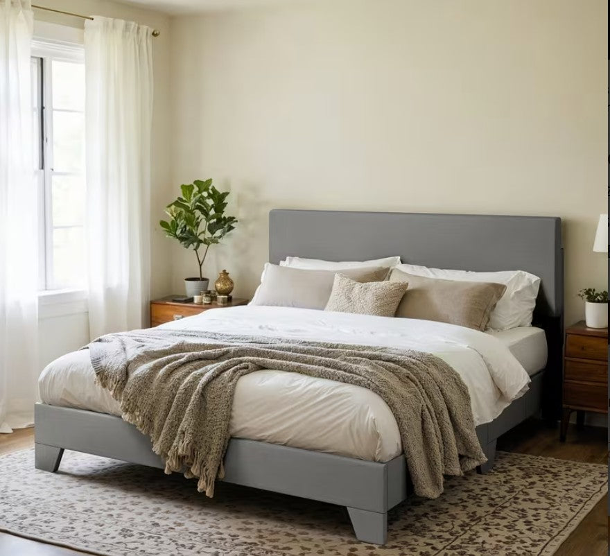 Welcoming scene featuring a beautifully made upholstered platform bed styled with elegant bedding.