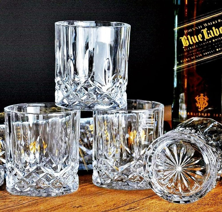 Crystal Whiskey Glasses filled with a rich, amber bourbon drink, highlighting their clarity and elegance.