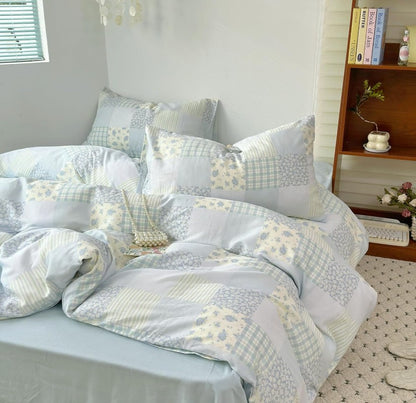 Elegant flat lay of Blue Floral Patchwork Cotton Gauze Duvet Cover Set, perfect for creating a calming coastal farmhouse look.