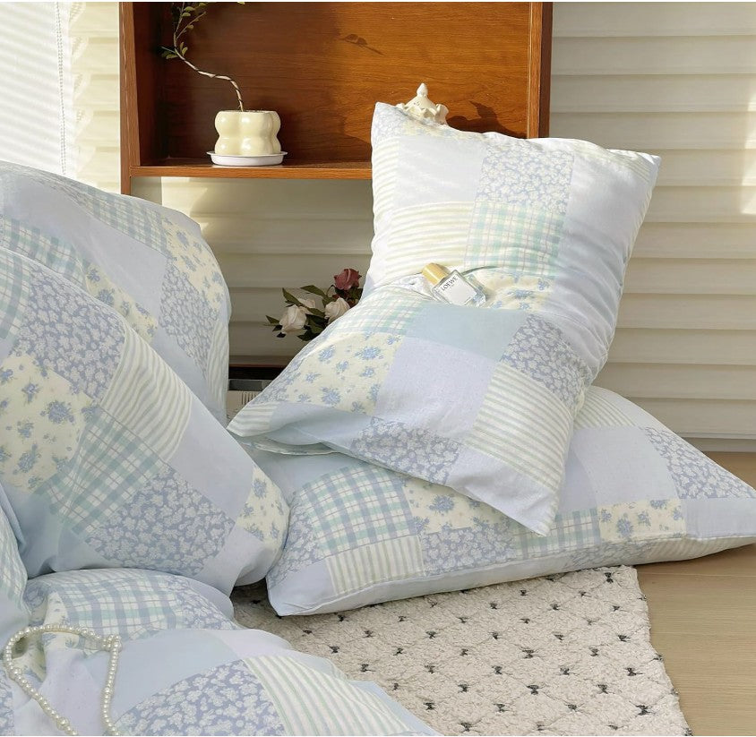 Image of Blue Floral Patchwork Cotton Gauze Duvet Cover Set paired with textured pillows and throws for a luxurious look.