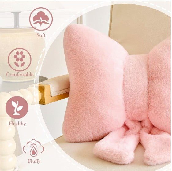 Charming pink bow throw pillow in a stylish living room setting, perfect for accenting furniture.