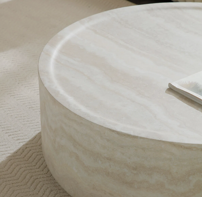 Chic faux marble coffee table with drum shape, perfect for a contemporary living area.