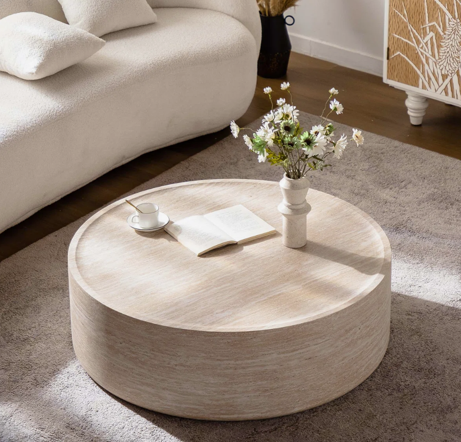 Living room styled with round faux marble coffee table, showcasing a fresh and modern arrangement.