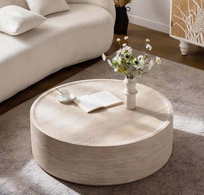Living room styled with round faux marble coffee table, showcasing a fresh and modern arrangement.