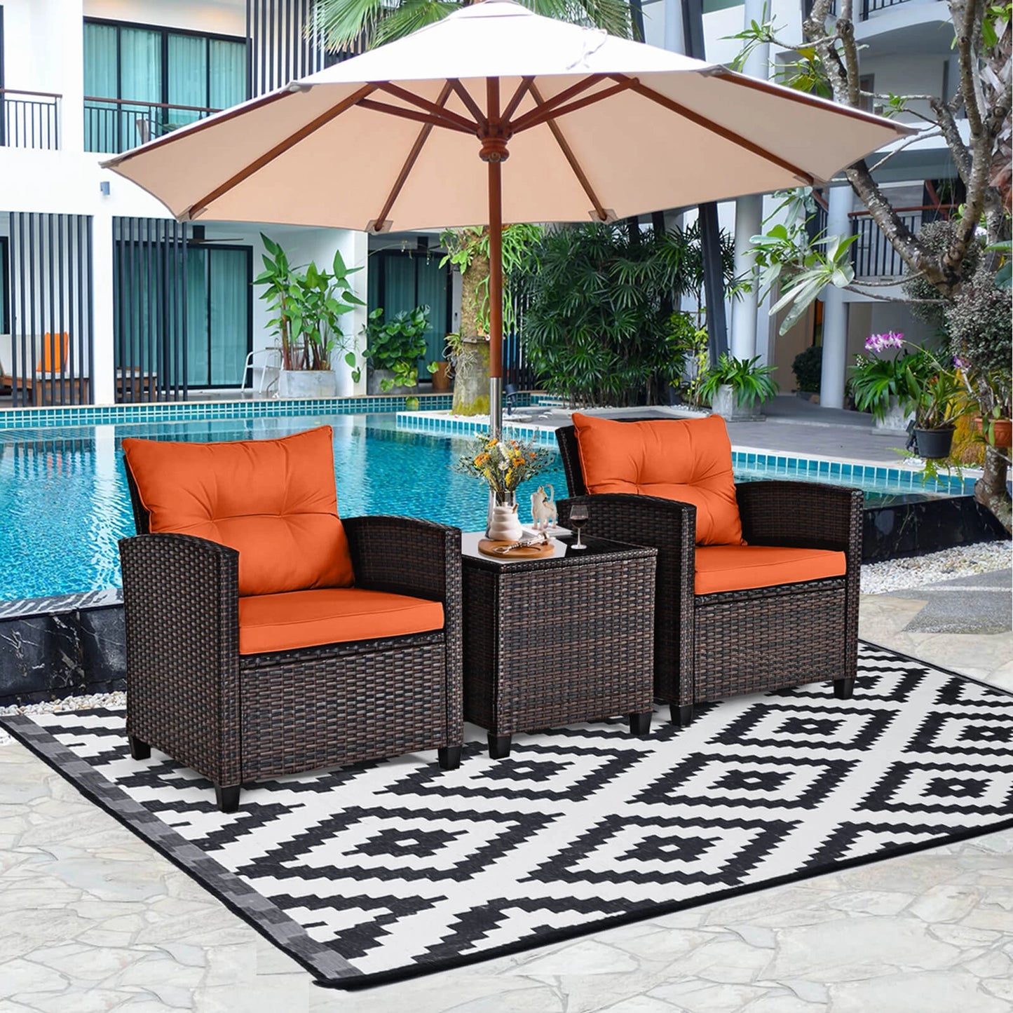 The 3-Piece Mixed Brown Rattan Wicker Bistro Set for Garden, Balcony & Poolside arranged beautifully in a garden setting, highlighting its elegant outdoor wicker bistro set design.