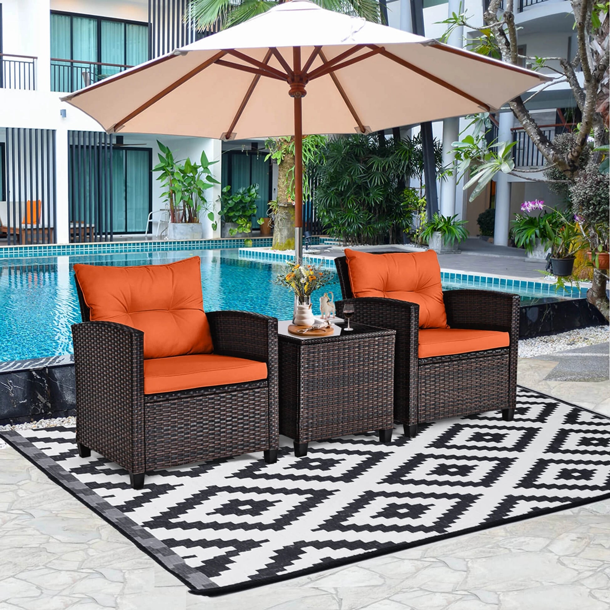 The 3-Piece Mixed Brown Rattan Wicker Bistro Set for Garden, Balcony & Poolside arranged beautifully in a garden setting, highlighting its elegant outdoor wicker bistro set design.