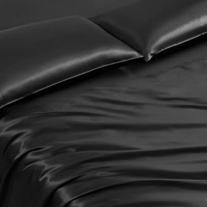 Laid-out Black Leopard Satin Comforter Set showing the full 8-piece bedding ensemble, perfect for a glamorous bedroom makeover.