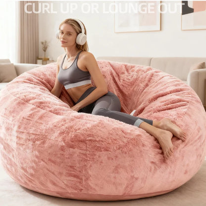Plush pink oversized faux fur bean bag chair for adults, perfect for relaxing or gaming.