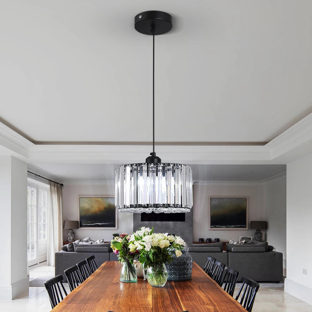 Modern LED Crystal Pendant Light in Gold or Black displayed in a dining area, showcasing elegant design and warm ambiance.