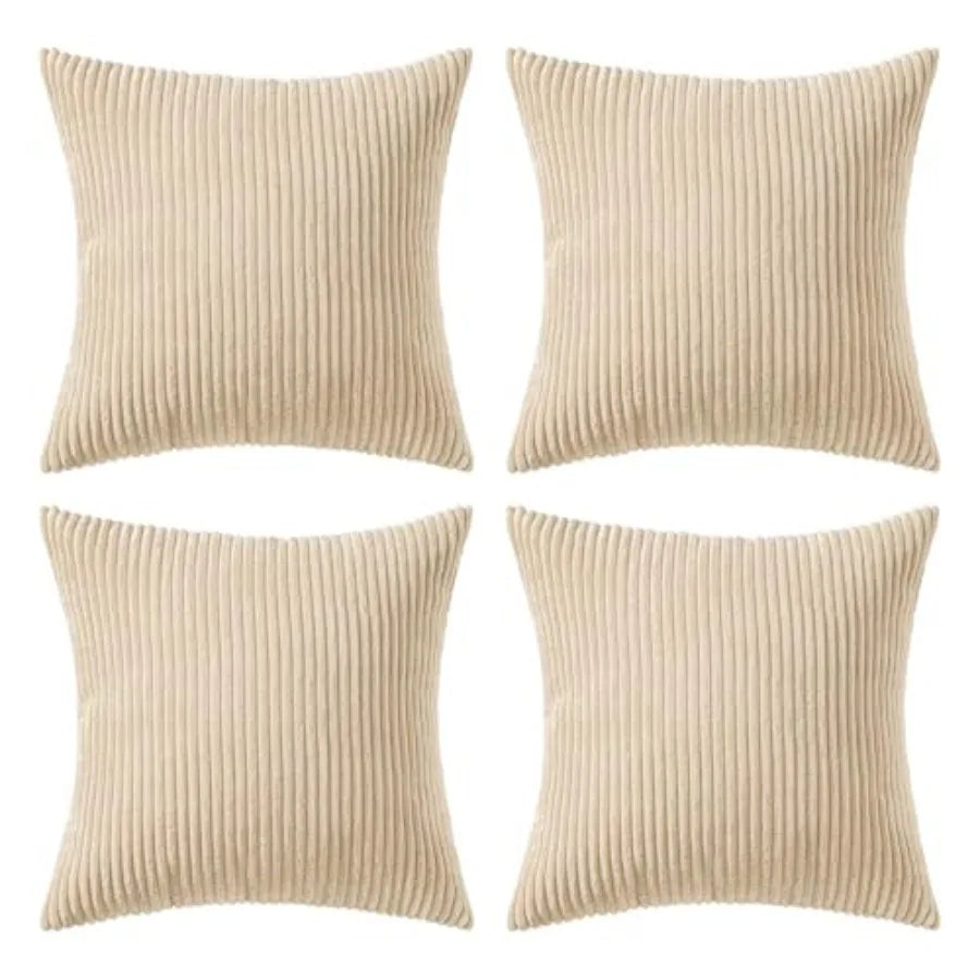 Four square throw pillows in a beige corduroy fabric, arranged in a 2x2 grid on a plain white background.