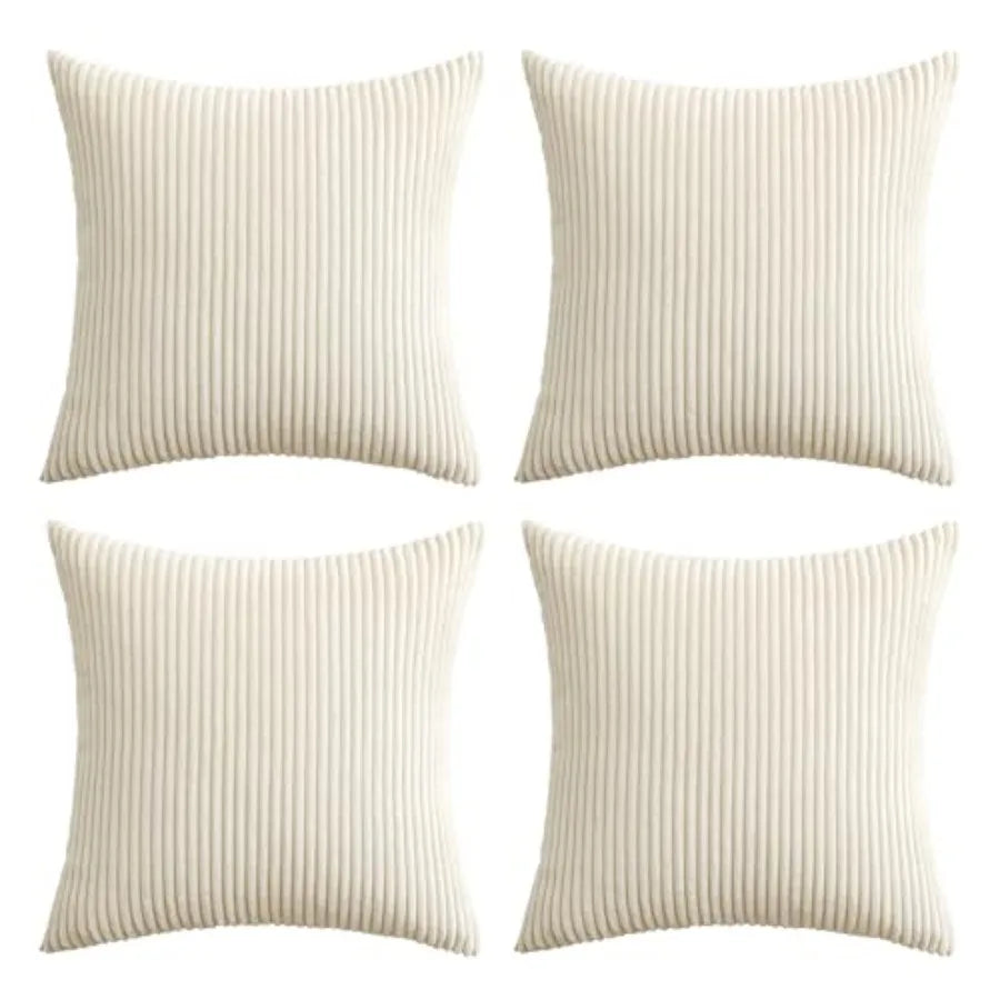 Four square throw pillows in a cream or off-white ribbed fabric, arranged in a 2x2 grid on a plain white background.