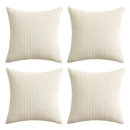 Four square throw pillows in a cream or off-white ribbed fabric, arranged in a 2x2 grid on a plain white background.