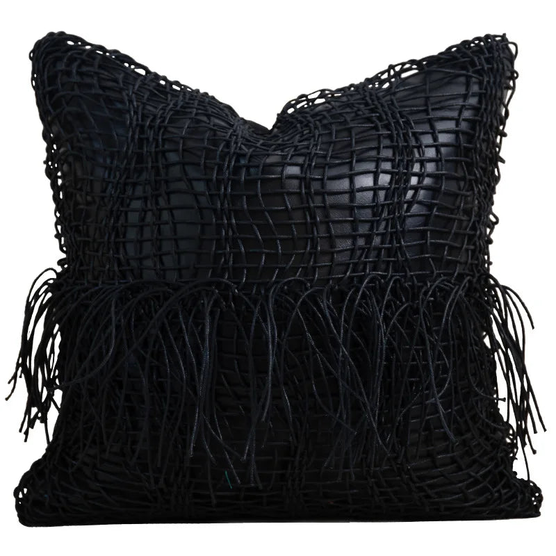 Tillbaka Faux Leather Throw Pillow Cover - Modern Minimalist Woven Hollow Design displayed as a black faux leather pillow cover on a modern sofa