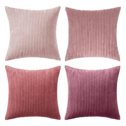Four pink ribbed pillow covers on a white background