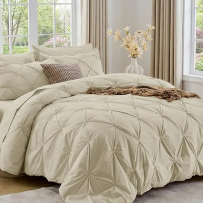 The cozy Queen comforter set features a luxurious pinch pleat pattern, providing both style and comfort in your personal retreat.