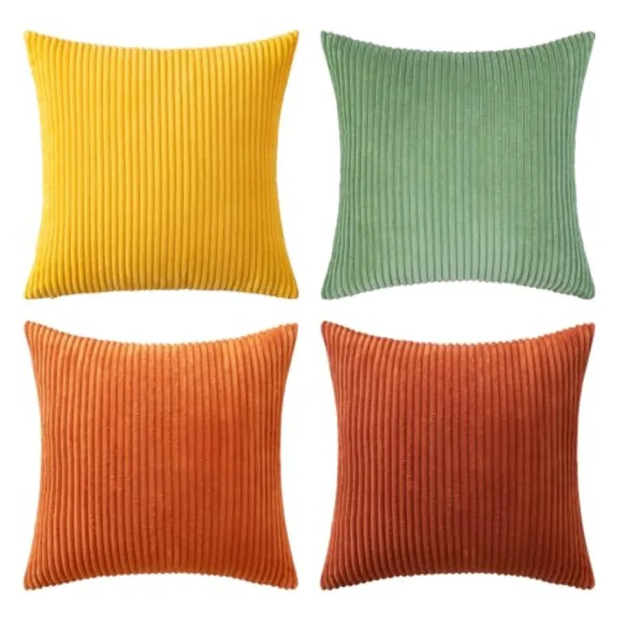 Four ribbed textured throw pillows in yellow, green, orange, and red on a white background.