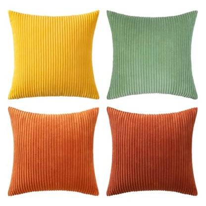 Four ribbed textured throw pillows in yellow, green, orange, and red on a white background.