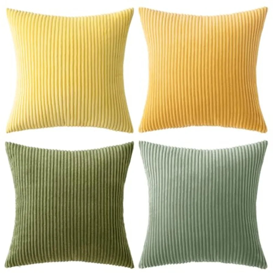 Four square ribbed throw pillows in yellow, mustard, olive green, and sage green, arranged in a 2x2 grid on a white background.