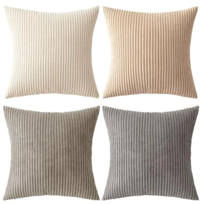 Four ribbed knit pillow covers in beige, brown, and gray on a white background.