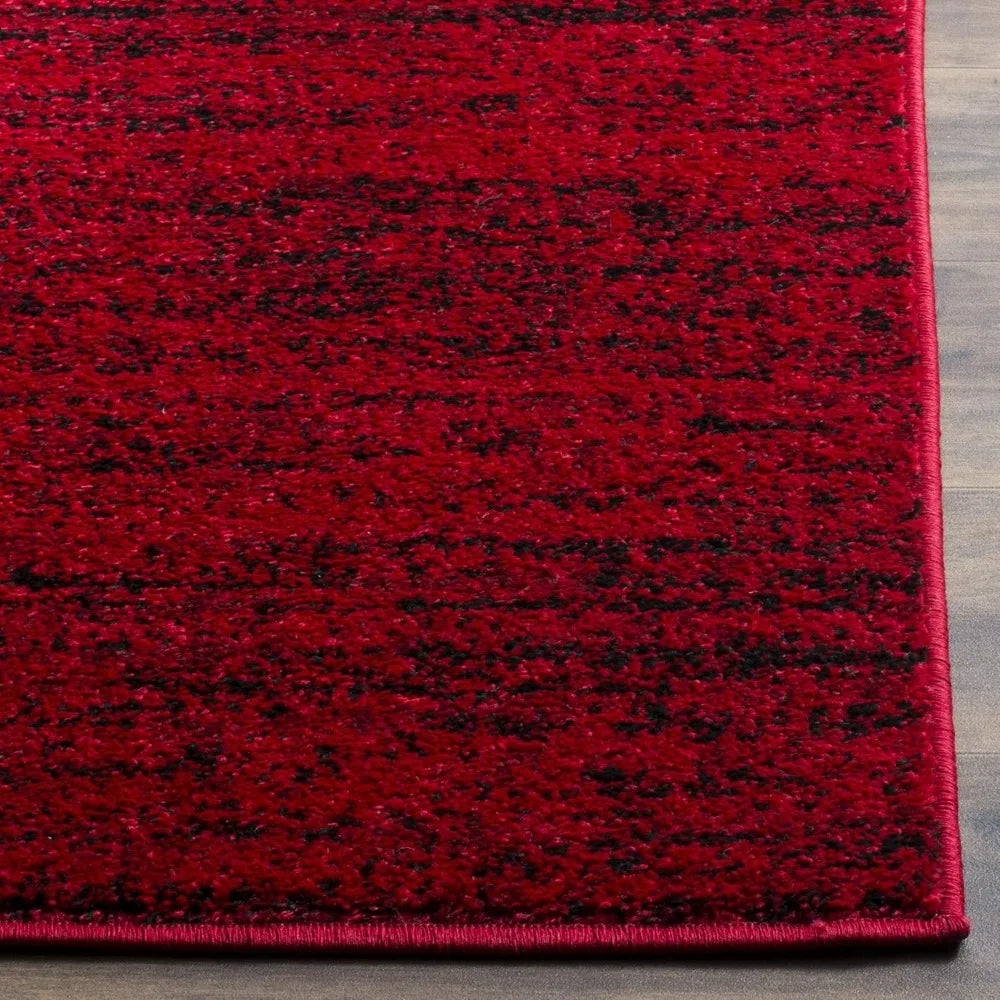 Modern Black & Red 6' x 9' Loomed Area Rug displayed in a bright setting, showcasing its non-shedding characteristics as a durable black and red rug.